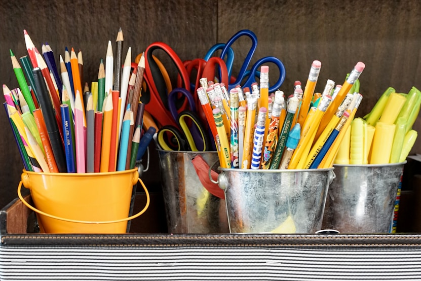 Three buckets of pencils and one bucket of scissors 